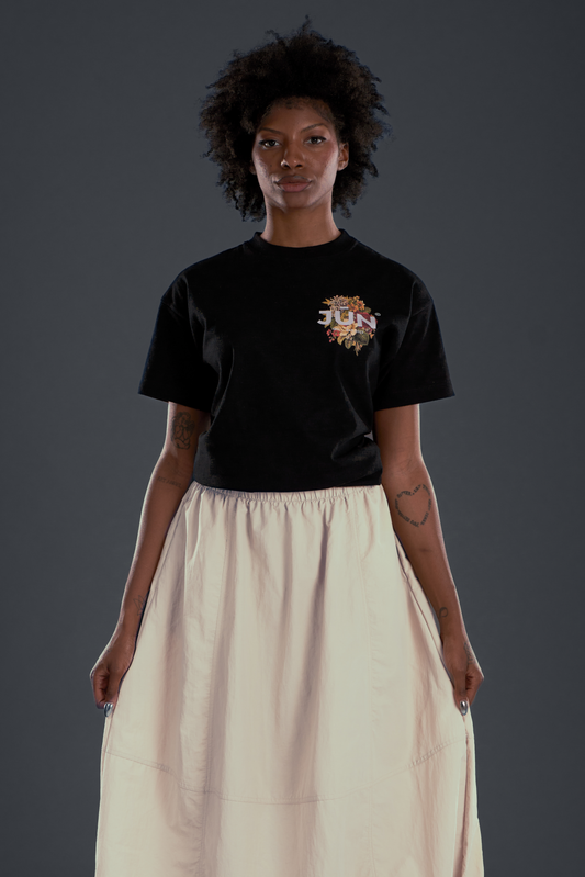 JŪN LOVE TEE. in black — front, worn, JŪN floral chest logo