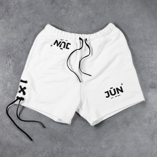 DAWN. SHORTS in white — flat lay, front, NYC and JŪN logo print