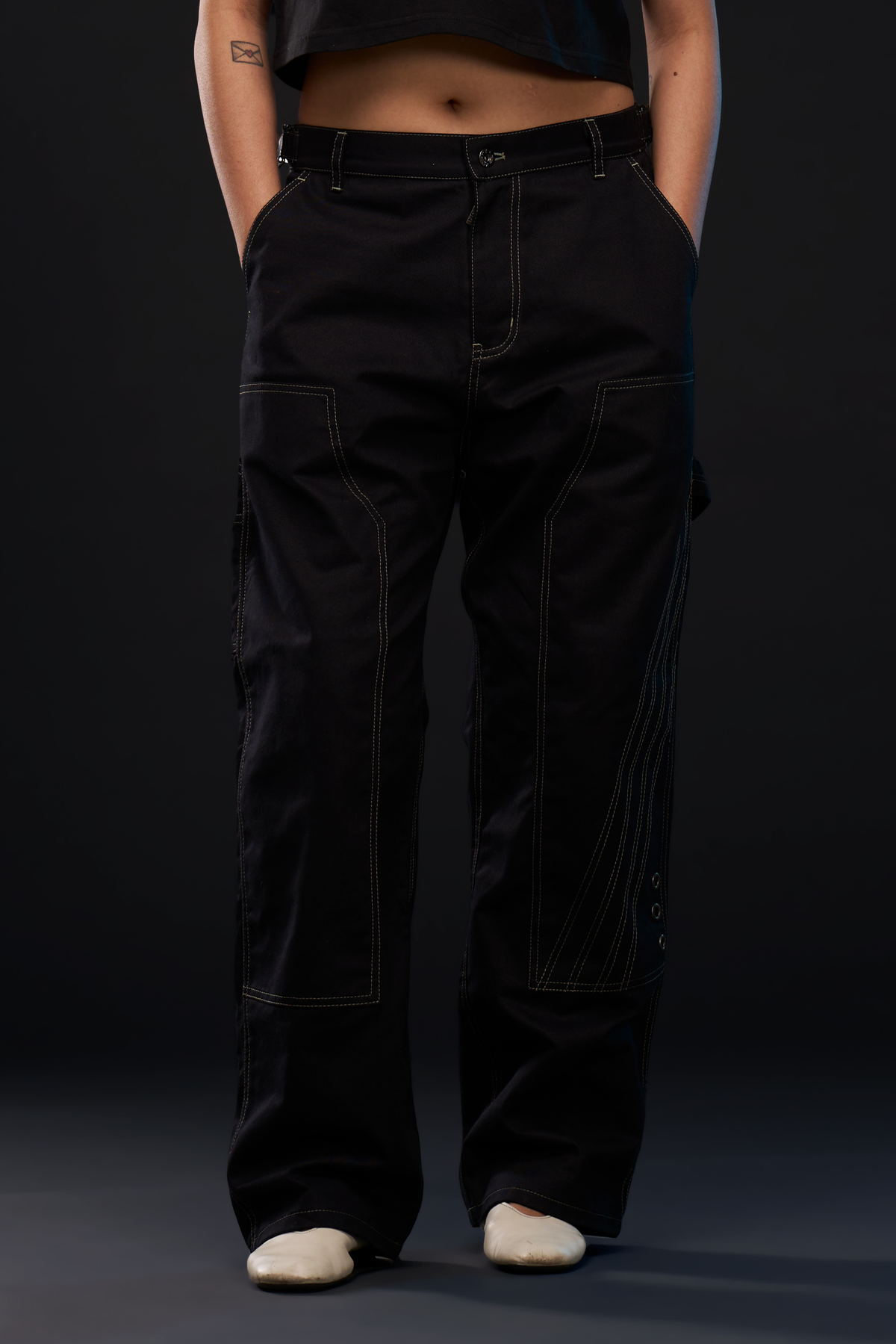 RIG. PANTS in black — front, worn on model, cropped