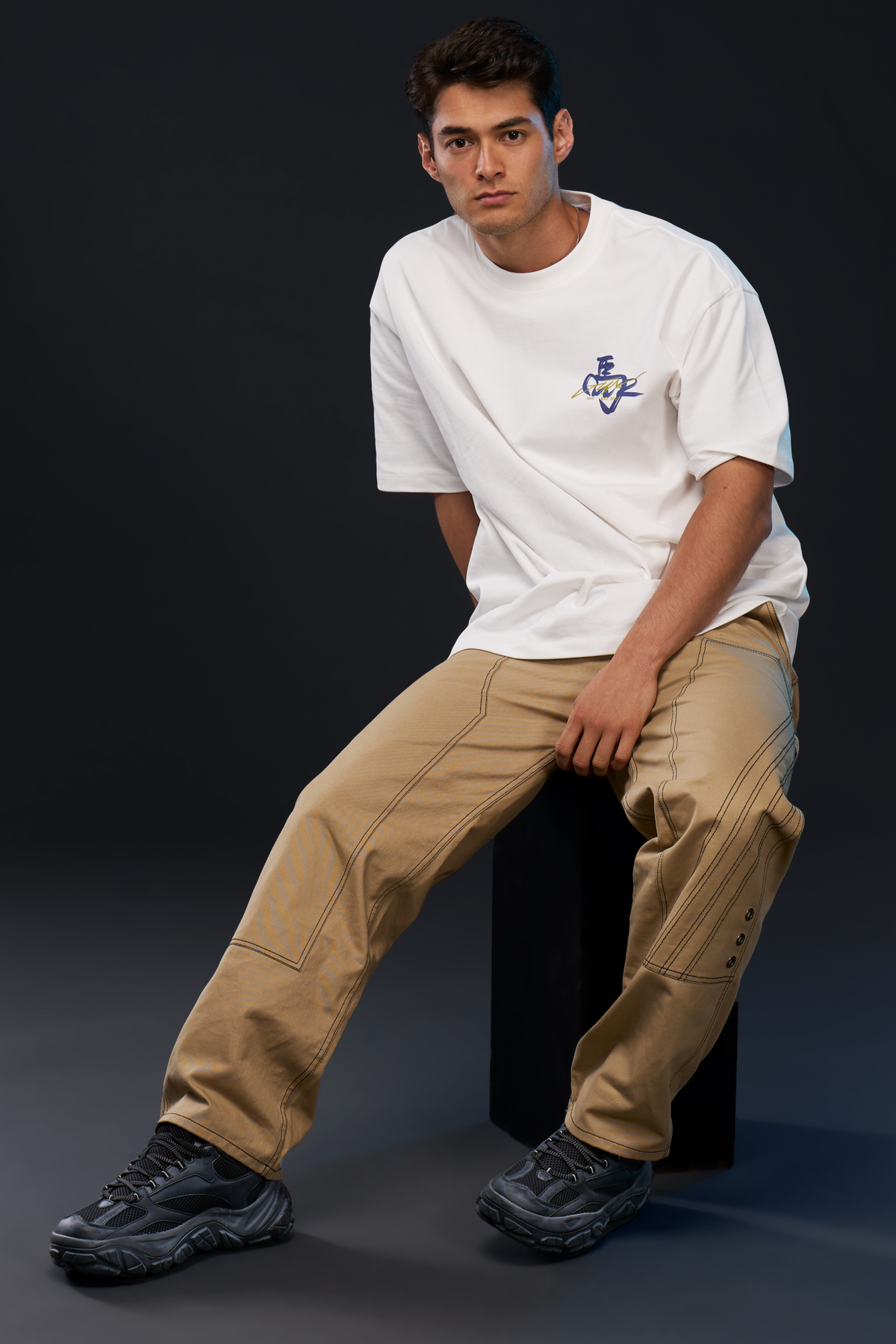 RIG. PANTS in khaki — worn on model, seated