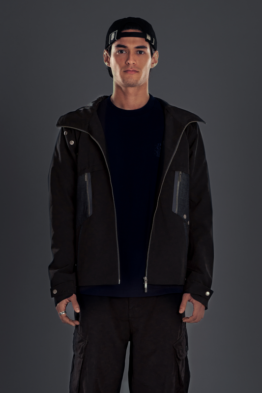 KAZE. WINDBREAKER in black — front, worn open, styled with cargo pants