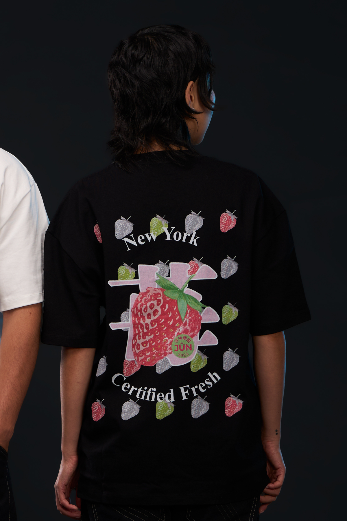 ICHIGO. TEE in black — worn, back, strawberry graphic with New York Certified Fresh text